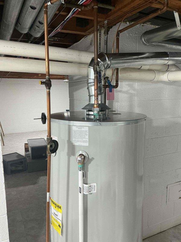 Completed comprehensive Gold AC Inspection on 10-year-old residential HVAC system with air handler/coil located in basement. Performed full system evaluation including visual inspection of all accessible components, ductwork, and mechanical connections. Documented water heater installation per protocol, noting proper copper piping connections, pressure relief valve configuration, gas valve assembly, and drain pan placement. Verified all plumbing connections, flue pipe installation, and safety labels present and legible. Inspected basement mechanical room including HVAC ductwork, electrical wiring, and overall equipment layout for proper installation and clearances.