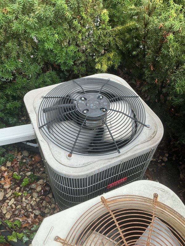 Completed routine AC tune-up maintenance on two 7-year-old outdoor condenser units as part of Gold Club membership. Performed comprehensive system inspection including electrical connections, refrigerant levels, amperage draws, and component operation. Both units operating within manufacturer specifications. Noted significant rust and corrosion on fan guards of both condensers due to prolonged weather exposure, though not affecting current system performance. Verified proper airflow through condenser coils, checked capacitor values, and ensured all safety controls functioning correctly. Replaced air filter and cleared debris from gravel pad surrounding units. Systems cooling efficiently with no immediate service needs identified. Recommended monitoring fan guard condition for potential future replacement to prevent deterioration of underlying components.