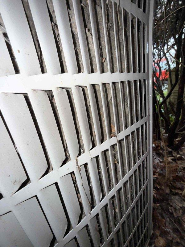 # No Cool Service Call - 25-Year-Old Bryant AC Unit

Responded to a no cooling complaint on a 25-year-old Bryant air conditioning system located on the side of the residence. Upon arrival, performed visual inspection of the outdoor condenser unit, which showed significant signs of age, weathering, and lack of maintenance. The unit exhibited heavy dirt accumulation, debris buildup around the base, and discoloration on cabinet panels.

Documented the overall condition of the equipment through photographs, noting the deteriorated state of the outdoor unit with dead leaves and organic matter surrounding the concrete pad. The condenser grille and cabinet showed weathering consistent with extended outdoor exposure and minimal preventive maintenance over its service life.

Given the advanced age of the system at 25 years—well beyond the typical 15-20 year lifespan of residential AC equipment—advised customer that the unit has exceeded its expected service life. Explained that parts availabili