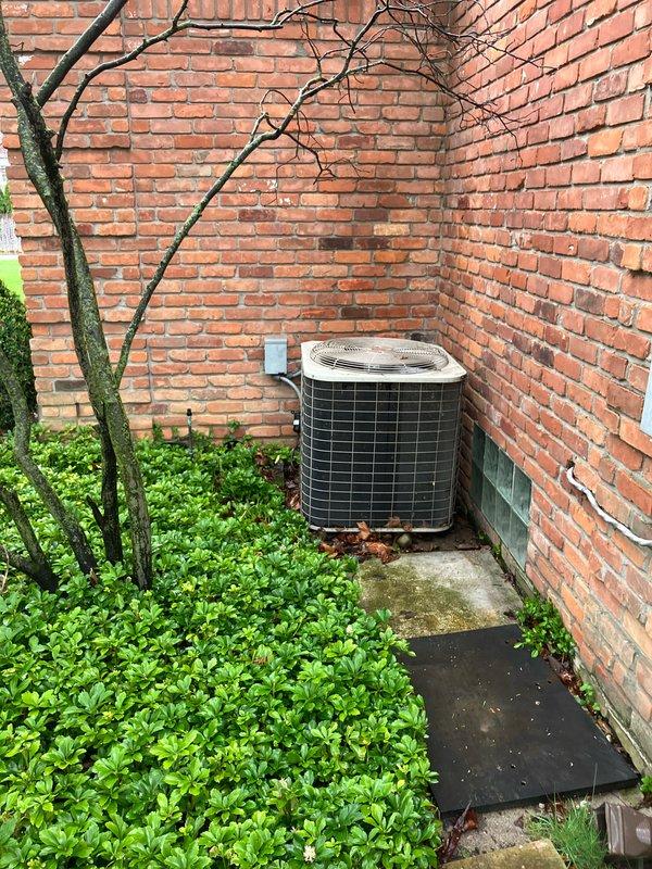Responded to service call for non-operational central air conditioning system with no heating or cooling capability. Performed comprehensive diagnostic evaluation of outdoor condensing unit located in exterior alcove and inspected electrical distribution panel to assess power supply and circuit breaker configuration. Documented equipment condition, installation environment, and electrical infrastructure through photographic evidence to support replacement estimate recommendations.