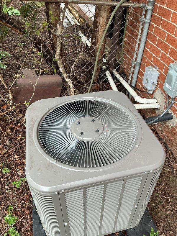Responded to customer complaint of insufficient cooling from 3-year-old air conditioning system. Performed visual inspection of indoor evaporator coil located in basement and outdoor condensing unit. Documented equipment condition with photographs showing furnace/air handler assembly with connected refrigerant lines and outdoor condenser unit positioned adjacent to building exterior. System components appeared operational with no obvious signs of mechanical failure or refrigerant leakage at time of inspection.