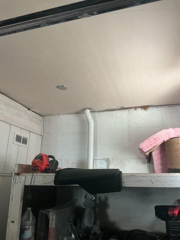 Responded to water leak complaint originating from second floor and manifesting through garage ceiling. Investigated plumbing fixtures in second floor bathroom and utility areas. Inspected under-sink plumbing assembly including P-trap, drain connections, and supply line fittings for signs of active leakage or moisture accumulation. Documented conditions with photographic evidence for customer records.