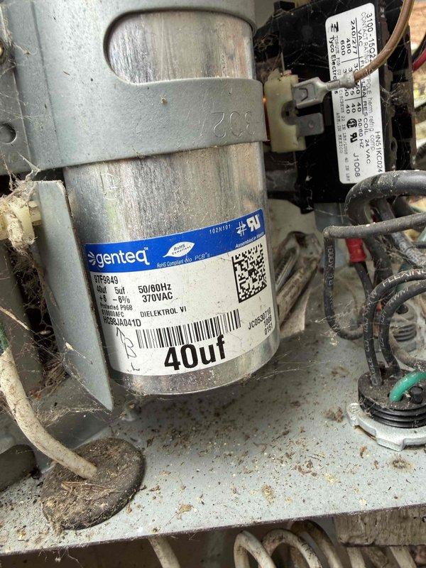 Responded to service call for 15-year-old air conditioning unit experiencing short cycling, where system would turn on and immediately shut off. Performed diagnostic evaluation of outdoor condenser unit located behind residence. Used digital clamp meter to test electrical parameters and identified failed run capacitor rated at 40µF on the Genteq condenser fan motor. Replaced defective capacitor, verified proper voltage supply at 370VAC, and confirmed all electrical connections were secure. Tested system operation and confirmed unit now runs through complete cooling cycles without interruption.