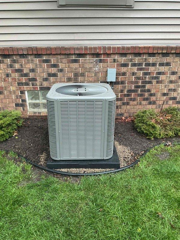 Completed installation of 2.5-ton air conditioning system with evaporator coil, positioning outdoor condenser unit on left side of property with proper pad placement and electrical conduit connection to building exterior. Indoor coil was installed in mechanical room and connected to existing furnace system with appropriate refrigerant lines and condensate drainage. Mechanical and electrical permits were obtained, with licensed electrician coordinating final power connections to ensure code compliance.