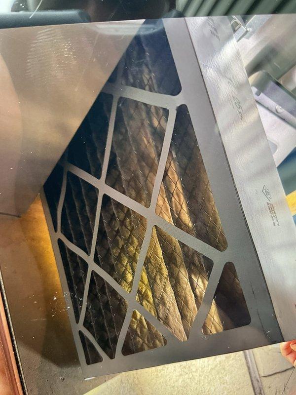 Completed comprehensive Gold AC inspection on a 1-year-old residential air conditioning system with air handler located in basement and condenser unit positioned on exterior pad. Performed thorough visual inspection of outdoor condenser unit, verifying proper placement on mounting pad, checking fan guard integrity, and confirming adequate clearance around unit. Inspected indoor air handler components including air filter condition and pleated filter media. Evaluated system accessibility and overall equipment condition. All components inspected showed proper installation and maintenance status consistent with newer equipment age. System confirmed operational at time of inspection.