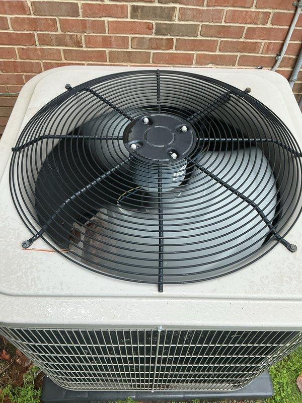 Completed comprehensive Gold AC Inspection and seasonal maintenance on two residential air conditioning systems (4-year-old and 6-year-old units) located at exterior and basement positions. Performed full system diagnostics including refrigerant level verification, electrical component testing, condenser coil cleaning, air filter inspection and replacement, thermostat calibration, and condensate drain line clearing. Inspected outdoor condenser unit with top-mounted fan assembly, verified proper operation of fan motor and protective wire guard, examined housing integrity and coil fins for damage or debris accumulation, and confirmed adequate airflow through perforated side grilles. Tested compressor amperage draw and capacitor performance to ensure optimal efficiency. Evaluated both systems for pre-summer readiness, finding units operating within manufacturer specifications with no immediate repairs required. Documented equipment condition through photographic records showing clean exte