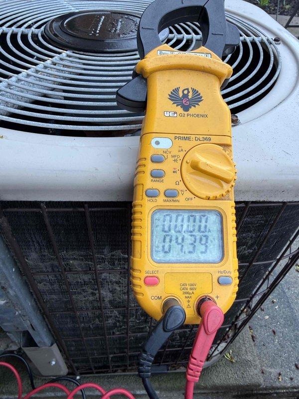 Responded to no cooling complaint on 34-year-old Amana air conditioning system. Upon arrival, confirmed unit was running but blowing warm air only, with outdoor fan motor operating. Performed diagnostic testing using digital multimeter to check electrical components and system operation. Given the advanced age of the equipment at 34 years—well beyond the typical 15-20 year lifespan of residential AC units—and the complete loss of cooling capacity, recommended system replacement rather than repair due to obsolete parts availability, decreased efficiency, and likelihood of additional imminent failures.