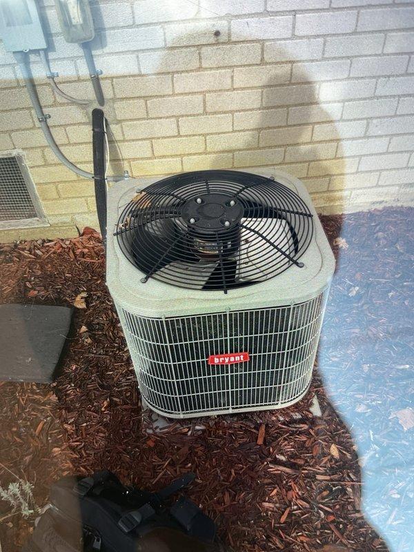 Completed comprehensive Gold AC inspection on multi-unit residential HVAC system with 11-year-old equipment. Inspected outdoor condenser unit positioned on exterior wall with proper clearance from debris, verified fan operation and examined electrical connections. Serviced basement-located air handler, inspected and evaluated pleated air filter condition within the unit, and assessed blower motor assembly and associated mechanical components. All systems operating within normal parameters at time of inspection.