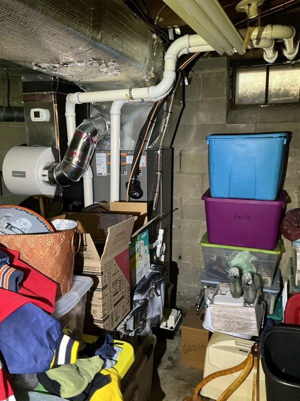 Performed comprehensive Gold-level AC inspection and system startup on 6-month-old HVAC system with air handler located in basement. Conducted thorough multi-point inspection of air handler unit, verified proper operation of all electrical components, and confirmed refrigerant lines with black insulation were properly secured and routed. Inspected white PVC condensate drain lines for proper pitch and drainage, examined metallic ductwork connections at plenum for air-tight seals, and verified all safety labels and manufacturer specifications were visible and intact. Checked outdoor condenser unit and confirmed surrounding area was clear of debris and obstructions for proper airflow. Tested system operation under current ambient conditions, verified temperature differential across evaporator coil, and confirmed equipment was cycling properly. All components functioning as designed with no deficiencies noted. System startup completed successfully and unit left in proper working order.