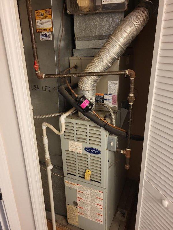 Conducted comprehensive site assessment for full HVAC system replacement estimate at residential property. Evaluated existing Carrier furnace installation located in confined utility closet, documenting current equipment configuration including ductwork connections, condensate drainage system with PVC piping, and copper refrigerant lines. Photographed equipment specifications, manufacturer labels, safety warnings, and existing installation conditions to determine appropriate replacement options. Assessed spatial constraints of closet installation, accessibility for future service work, and compatibility requirements for new system components including furnace unit, air handler, and associated ventilation infrastructure.