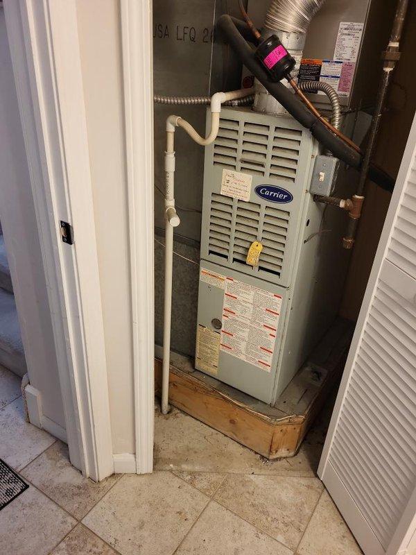 Conducted comprehensive site assessment for full HVAC system replacement estimate at residential property. Evaluated existing Carrier furnace installation located in confined utility closet, documenting current equipment configuration including ductwork connections, condensate drainage system with PVC piping, and copper refrigerant lines. Photographed equipment specifications, manufacturer labels, safety warnings, and existing installation conditions to determine appropriate replacement options. Assessed spatial constraints of closet installation, accessibility for future service work, and compatibility requirements for new system components including furnace unit, air handler, and associated ventilation infrastructure.