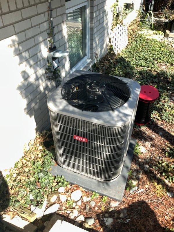 Completed comprehensive Gold AC Inspection on 2012 Bryant residential split system with basement-mounted air handler and exterior condenser unit. Performed full system evaluation including visual inspection of indoor furnace/air handler assembly and outdoor condensing unit, verified operational status of all components, checked refrigerant lines and electrical connections, and documented equipment condition with photographic records. System found to be in working order at time of inspection, with technician arrival coordinated per homeowner's requested ten o'clock schedule.