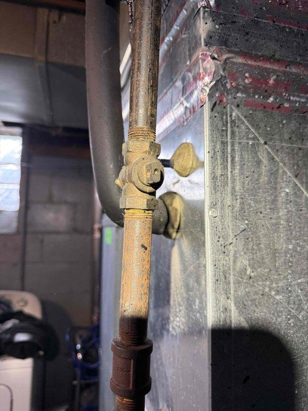 Responded to no-cooling call on 10+ year old air conditioning system with outdoor condenser and basement air handler. Performed diagnostic testing on system after customer reported fan failure to engage when AC was activated. Used multimeter to test electrical connections and voltage readings at furnace/air handler unit, inspecting burner assembly area and associated wiring harnesses. Identified issue preventing proper fan operation and completed necessary repairs to restore system functionality.