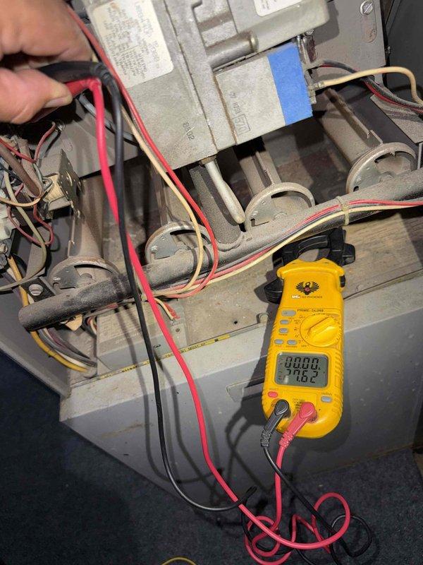 Responded to no-cooling call on 10+ year old air conditioning system with outdoor condenser and basement air handler. Performed diagnostic testing on system after customer reported fan failure to engage when AC was activated. Used multimeter to test electrical connections and voltage readings at furnace/air handler unit, inspecting burner assembly area and associated wiring harnesses. Identified issue preventing proper fan operation and completed necessary repairs to restore system functionality.