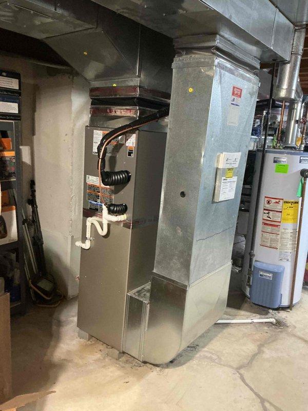 Completed installation of 2-ton air conditioning system with new evaporator coil in rear-located outdoor unit. Installed new AC condenser and indoor coil assembly, connecting to existing furnace in basement mechanical room. Reconnected all electrical components per code requirements. Mechanical and electrical permits were obtained prior to installation. System was fully charged, tested for proper operation, and verified for optimal airflow and refrigerant levels. All ductwork connections were secured and sealed. Unit is operational and cooling efficiently.