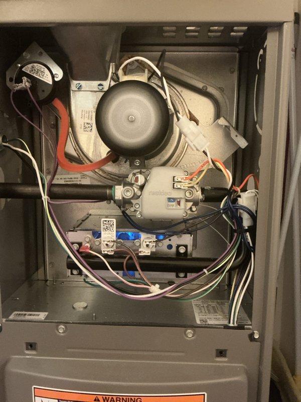Completed comprehensive tune-up service on a 2-year-old furnace and air conditioning system located in the laundry area. Performed full inspection of furnace internal components including blower motor assembly, gas valve connections, pressure switches, and electrical wiring harnesses; verified all safety controls and burner operation. Inspected outdoor condenser unit including fan motor operation, coil condition, and refrigerant pressures; cleaned condenser coils and confirmed proper airflow through louvers.