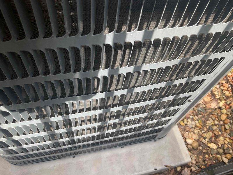 Completed AC inspection on Goodman outdoor condenser unit less than 10 years old. Unit was operational and located on concrete pad with proper clearance. Performed visual inspection of exterior components, grille, and fan assembly, confirming all components were clean and well-maintained with no visible damage or debris buildup.