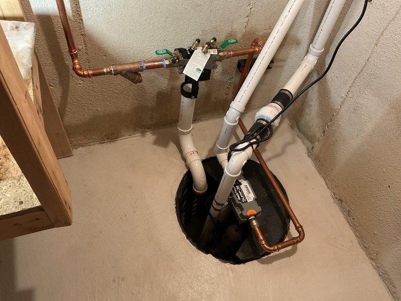 Responded to service call for sump pump system cycling issue where unit was running frequently but shutting off after 5-10 seconds of operation. Inspected water-powered backup sump pump with primary pump installation from May 2025. Examined all plumbing connections, including copper supply lines, PVC discharge piping, and brass fittings at wall-mounted valve assembly. Verified proper installation of backup system components and checked for potential causes of short cycling including float switch malfunction, check valve issues, or pressure imbalances in the water-powered ejector system. Assessed sump basin configuration with multiple inlet pipes and confirmed electrical connections to primary pump. Documented existing installation with spray foam insulated walls and multi-pipe configuration serving the dual pump system.