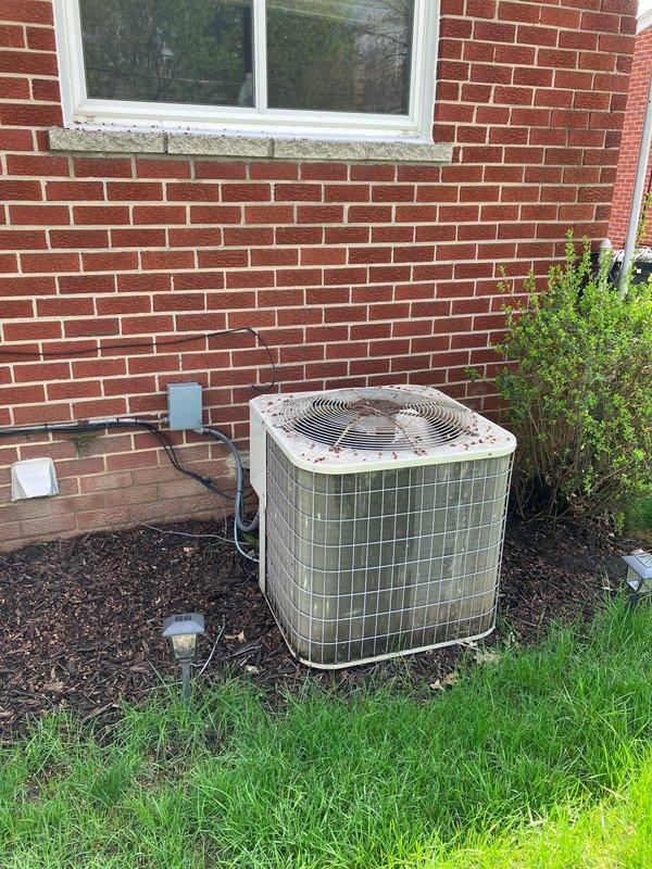 Provided estimate for complete air conditioning system replacement. Existing 2007 system was non-functional with complete R22 refrigerant loss as previously diagnosed by another contractor. Assessed outdoor condensing unit located against brick exterior and basement furnace installation to determine replacement specifications and compatibility requirements for new equipment.