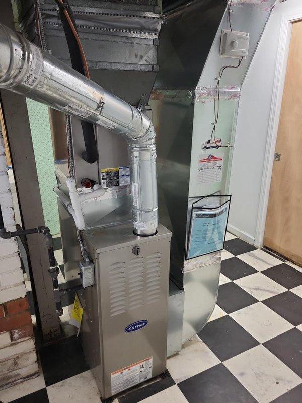 Completed HVAC system evaluation for residential property with 10+ year old air conditioning equipment reported to be low on refrigerant. Performed comprehensive inspection of basement-installed Carrier furnace, evaporator coil assembly, and associated ductwork components. Documented existing equipment configuration including plenum assembly, copper refrigerant lines, humidifier unit, and metal ductwork distribution system. Provided replacement estimate quotes for aging HVAC system to address refrigerant deficiency and equipment performance concerns for new homeowner.
