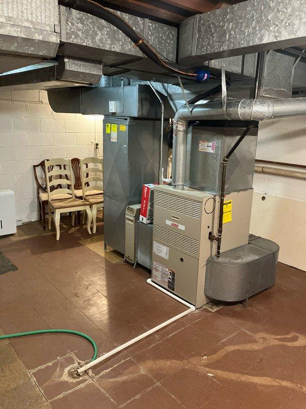 Conducted comprehensive assessment of residential HVAC system following customer report of non-functional air conditioning. Diagnosed failed compressor on existing 3-phase central air conditioning unit, rendering cooling system inoperable. Inspected 24-year-old gas furnace currently providing functional heating but nearing end of service life. Documented exterior condenser unit mounted on brick exterior and interior furnace/air handler installation in basement mechanical room. Prepared detailed estimate for complete AC replacement due to compressor failure and provided options for simultaneous furnace upgrade to improve system efficiency and prevent future emergency replacement needs.