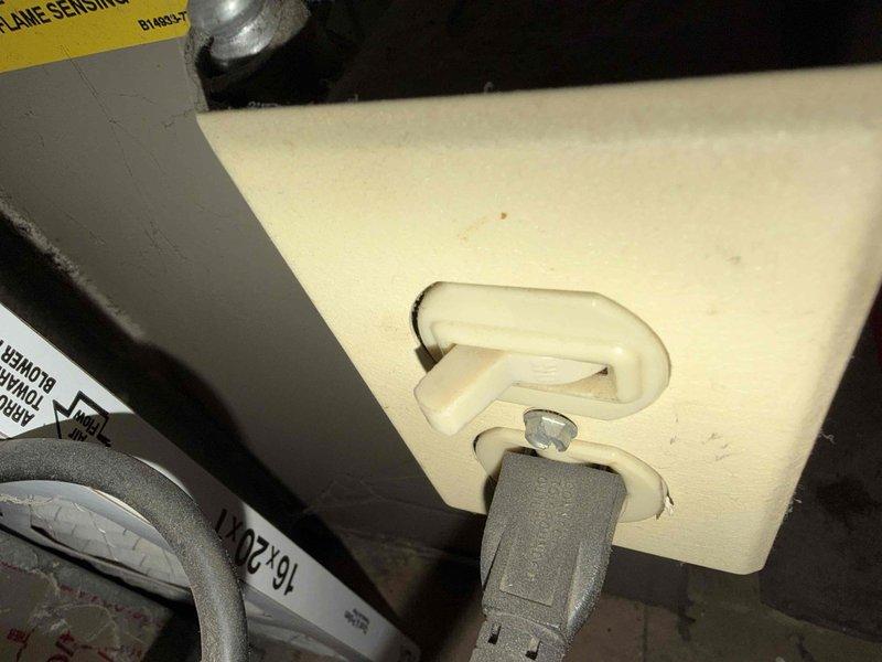 Responded to customer report of gas odor during furnace burner ignition. Upon inspection, found flame-sensitive insulation blanket improperly positioned near burner assembly, creating potential combustion concern. Identified corroded gas line connection with visible deterioration and mineral deposits on threaded fitting, which was determined to be the source of gas smell during startup. Repositioned insulation blanket to manufacturer specifications and secured with appropriate fasteners. Recommended immediate gas line repair or replacement due to advanced corrosion on connection fitting to prevent future gas leaks. Unit currently operational and heating properly, but customer advised of safety concern requiring follow-up service for corroded gas piping.