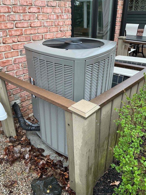 Completed Gold AC inspection on dual-unit residential HVAC system with 2024 equipment featuring basement-located air handler and exterior condenser unit. Performed comprehensive multi-point inspection including verification of system operation, examination of condenser unit mounted on elevated wooden platform with proper clearance, assessment of return air grille showing normal dust accumulation, and confirmation that outdoor unit maintained adequate airflow through louvered vents with top-mounted fan assembly functioning properly.