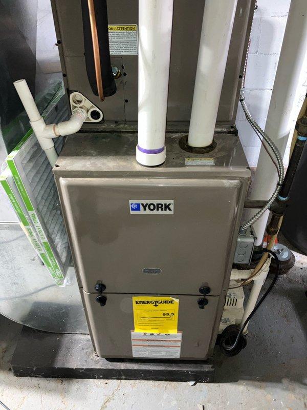 Provided estimate for replacement of non-operational 7-year-old air conditioning system with outdoor condenser unit located against exterior brick wall and York furnace system installed in basement. Evaluated existing equipment configuration including PVC venting, refrigerant lines, condensate drainage, and electrical connections to determine replacement specifications and installation requirements.