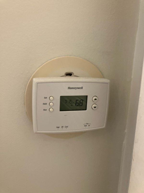 Completed comprehensive HVAC estimate for full system replacement on multi-unit residential building. System assessment revealed ZR-22 refrigerant system was completely empty, indicating major leak or component failure requiring full system replacement rather than repair. Documented existing exterior utility infrastructure including electrical metering and conduit configuration for proper system sizing and electrical load calculations, and photographed current Honeywell programmable thermostat for replacement specifications and compatibility requirements.