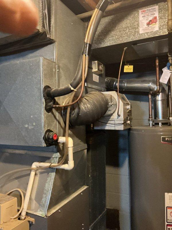 Performed comprehensive inspection, deep cleaning, and pad replacement on aging furnace-mounted humidifier unit located in basement storage room. Removed accumulated mineral deposits and biological growth from water panel assembly, cleaned distribution tray and reservoir, and installed new evaporator pad to restore proper humidity output and prevent mold development. Verified water supply line flow, checked drain functionality, and confirmed unit operation following service completion.
