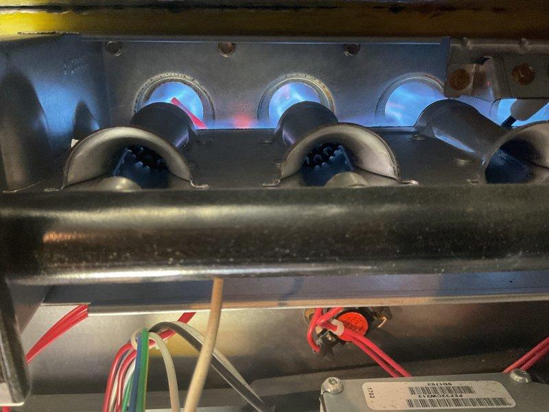 Completed comprehensive furnace inspection on 2017 unit located in basement. Performed thorough examination of all system components including burner assembly operation, air filter condition, humidifier functionality, thermostat calibration, and hot water tank status. Verified proper flame characteristics with blue combustion pattern visible through inspection ports, confirmed clean air filter with no excessive dust accumulation, and documented all equipment operating within normal parameters.