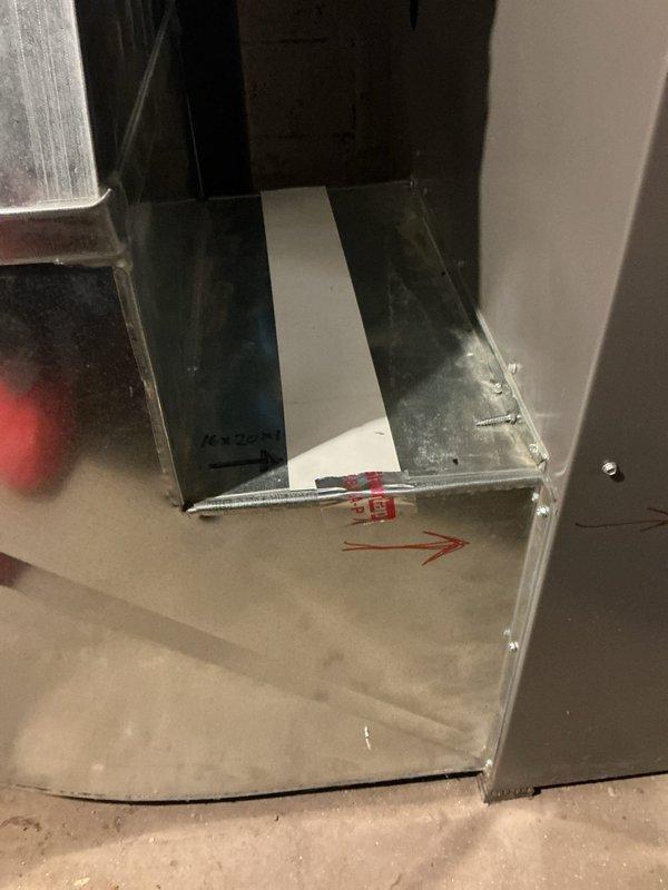 Responded to service call for furnace repair estimate on 6-year-old Lennox unit located in basement. Upon arrival, confirmed unit was operational and providing heat. Performed comprehensive visual inspection of furnace cabinet, ductwork connections, and surrounding installation area. Documented existing conditions with photographs showing main supply duct transition at floor level and overall furnace installation with vertical supply plenum. Noted typical dust accumulation on ductwork surfaces consistent with system age. Verified furnace accessibility and clearances meet code requirements. Unit remains functional at time of inspection. Provided customer with assessment findings and repair estimate for consideration.