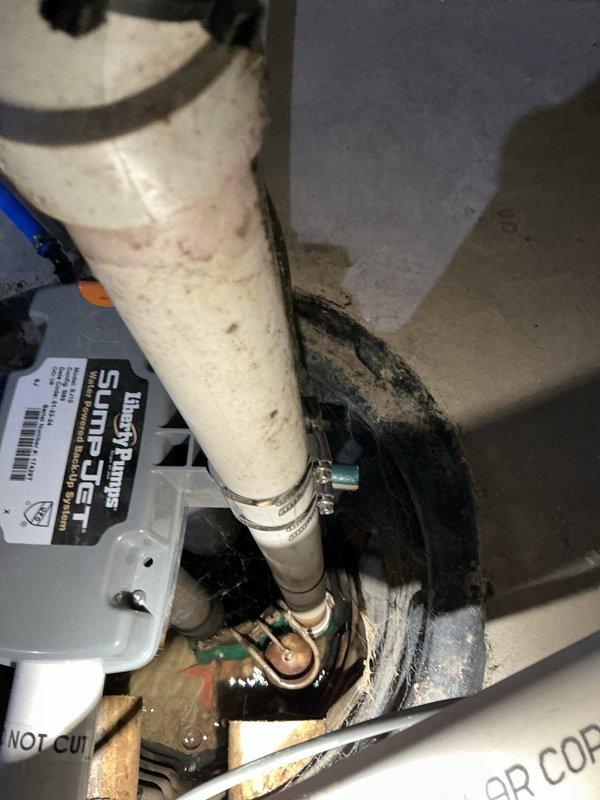 Responded to service call for non-operational sump pump system. Upon arrival, performed diagnostic assessment of the sump pump assembly and associated discharge plumbing. Inspection revealed heavily corroded elbow joint connection and deteriorated PVC discharge piping with significant mineral deposits and debris accumulation. The corroded fitting was compromising system integrity and preventing proper pump operation. Replaced failed components including the corroded elbow joint with new SurePro fittings to restore proper drainage function. Tested system operation to verify pump cycling and discharge flow were functioning correctly. System returned to full operational status.