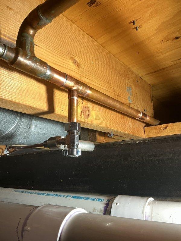 Responded to a slow leak in the basement of a 40-year-old residential property. Upon inspection of the crawl space, located the source of the leak in the copper supply line system running through the floor joists. The aging copper piping showed signs of corrosion and patina consistent with the home's age. Identified a compromised joint connection that had been slowly dripping for approximately 24 hours. Repaired the affected section by replacing the faulty fitting and securing all connections. Verified the integrity of surrounding copper pipes and PVC drainage lines. Tested the system for proper water pressure and confirmed no additional leaks were present. Documented the existing plumbing infrastructure with photographs for maintenance records. The repair was completed successfully with no further water intrusion detected.