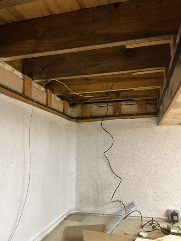 Performed diagnostic evaluation on basement-located furnace to assess equipment condition and determine repair versus replacement recommendations. Conducted thorough inspection of heating system, including visual assessment of furnace components, ductwork connections, and associated plumbing infrastructure in basement ceiling area. Documented equipment condition through photographic evidence showing exposed joists, utility piping, and structural elements surrounding the HVAC installation for comprehensive evaluation and estimate preparation.