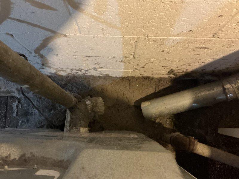 Provided quote for replacement of dryer vent ductwork in basement utility area. Inspected existing flexible metallic ductwork running vertically along wall, noting aged condition with visible wear and discoloration. Assessed connection points between ductwork and wall penetrations, observing moisture staining and debris accumulation at base. Documented current state of ventilation system and surrounding plumbing infrastructure for estimate preparation.