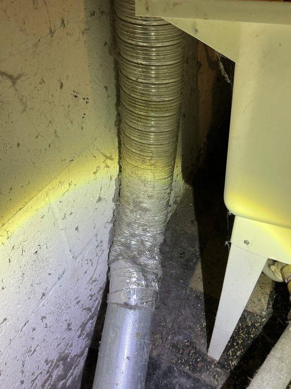 Provided quote for replacement of dryer vent ductwork in basement utility area. Inspected existing flexible metallic ductwork running vertically along wall, noting aged condition with visible wear and discoloration. Assessed connection points between ductwork and wall penetrations, observing moisture staining and debris accumulation at base. Documented current state of ventilation system and surrounding plumbing infrastructure for estimate preparation.