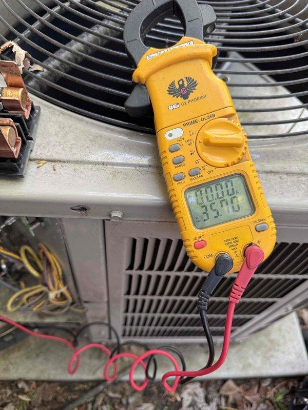 Responded to no-cooling call on 10+ year old air conditioning system located in basement. Upon arrival, performed diagnostic evaluation of outdoor condensing unit that failed to start when turned on. Using digital multimeter and clamp meter, tested electrical components and measured amperage draw to determine system operability. Found unit non-functional and assessed overall condition of aged equipment surrounded by debris and showing signs of weathering. Documented findings with diagnostic measurements and provided assessment regarding potential need for system replacement.