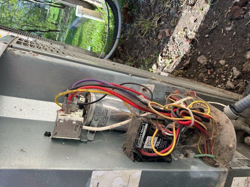 Completed comprehensive Gold AC Inspection and preventative maintenance on three 17-year-old air conditioning systems located in the attic, basement, and garage. Performed thorough tune-up procedures on all units including inspection of condenser coils, fan assemblies, electrical connections, capacitors, and contactors. Documented existing conditions with photographic evidence showing outdoor condenser unit with cylindrical configuration, protective fan guard, and unit placement on concrete pad. Inspected electrical control panel and disconnect box, noting age-related corrosion and weathering on metal components and housing consistent with 17-year-old equipment exposed to outdoor conditions. Verified proper operation of all three systems and ensured standard HVAC control wiring connections were secure across all units.