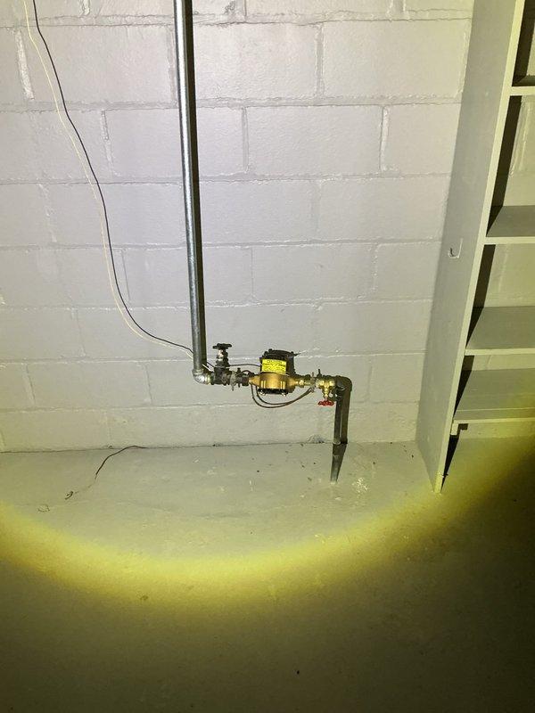 Completed comprehensive whole home plumbing inspection at homeowner's request. Inspection revealed significant water intrusion in basement utility area with standing water covering concrete floor, indicating active flooding condition requiring immediate attention. Documented plumbing infrastructure including gas line installations with brass regulator valve, water supply systems, utility sink with standard faucet fixture, and various vertical pipe runs along concrete block walls. Identified need for separate appointment to address HVAC system inspection focusing on furnace and ductwork as requested by homeowner during scheduled visit.