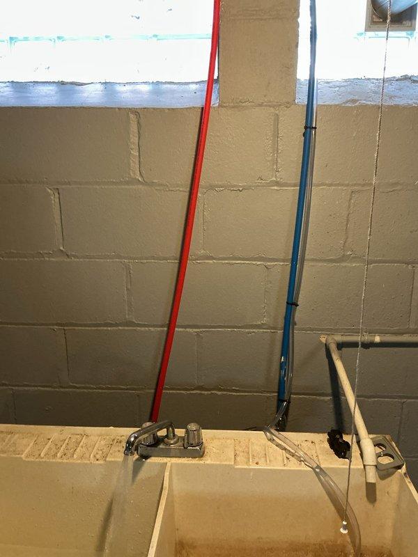 Completed comprehensive whole home plumbing inspection at homeowner's request. Inspection revealed significant water intrusion in basement utility area with standing water covering concrete floor, indicating active flooding condition requiring immediate attention. Documented plumbing infrastructure including gas line installations with brass regulator valve, water supply systems, utility sink with standard faucet fixture, and various vertical pipe runs along concrete block walls. Identified need for separate appointment to address HVAC system inspection focusing on furnace and ductwork as requested by homeowner during scheduled visit.