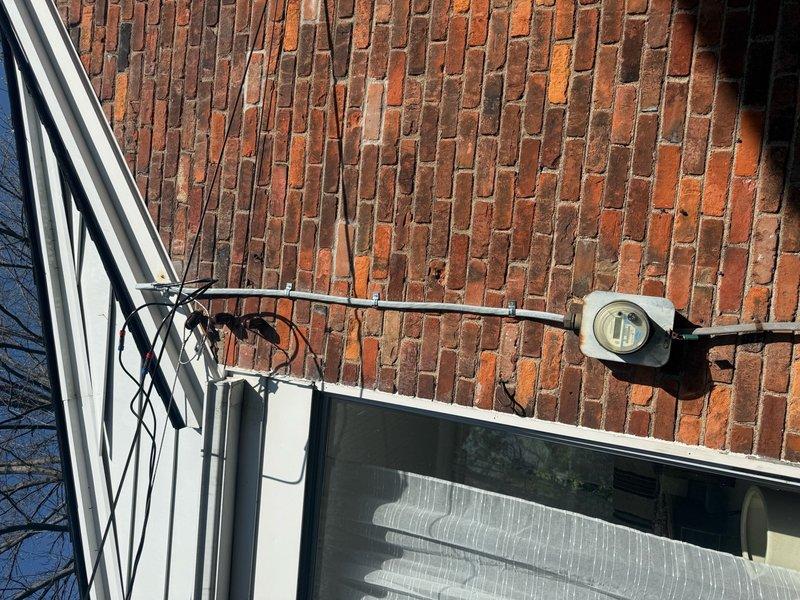 Performed comprehensive whole home electrical inspection following reports of cut ground wire and multiple electrical deficiencies in recently renovated property. Conducted thorough evaluation of main electrical panel, identifying disorganized wiring, improper wire management, and potential code violations including questionable wire connections with aftermarket connectors. Inspected exterior electrical fixtures and service entrance components, documenting conditions of outdoor lighting fixtures and service conductors mounted to building exterior. Photographed panel interior showing circuit breaker arrangement, bus bar configuration, and wire routing for documentation and future reference. Assessment revealed multiple areas requiring attention consistent with substandard installation practices, providing homeowner with detailed findings to address safety concerns and bring electrical system into compliance with current standards.