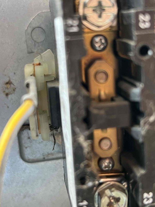 Completed comprehensive Gold AC inspection on 10+ year old residential air conditioning system with air handler/coil located in basement. Performed thorough multi-point inspection including examination of condensate drain line at exterior foundation, verified proper installation of flexible drainage hose with secure metal clamp connections at brick wall penetration. Inspected electrical components and terminal connections within system, confirmed all wiring terminations secure on terminal strip with proper grounding connections in place. Unit currently operational with no immediate service needs identified. All system components photographed and documented for maintenance records.