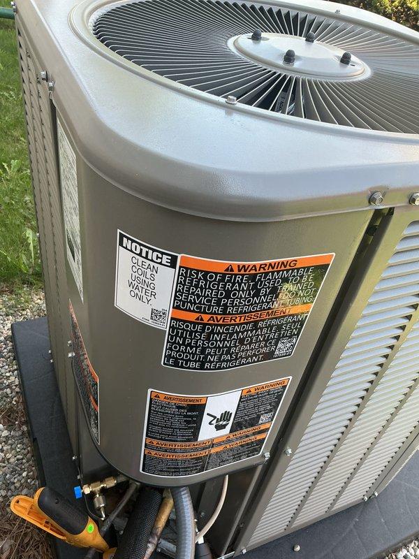 Completed system start-up and commissioning of newly installed HVAC system, including outdoor condensing unit and indoor air handler equipment. Verified proper refrigerant charge levels using manifold gauges at outdoor unit service ports, confirmed all electrical connections and safety labels were in place, and tested condensate drain P-trap configuration for proper operation. System operational checks confirmed unit is functioning within manufacturer specifications with all components operating correctly.