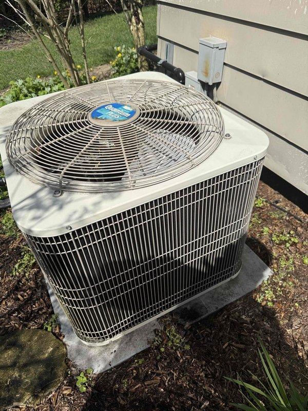 Completed comprehensive Gold AC inspection on single residential unit over 10 years old with air handler located in basement. Performed thorough evaluation of outdoor condenser unit, which showed good overall condition with clean vertical fins and minimal debris accumulation. Conducted electrical measurements using digital clamp meter to verify proper amperage draw and system performance. Unit was operational at time of inspection with no immediate issues identified. Documented equipment condition through photographic records showing condenser placement, clearances, and electrical disconnect box positioning.