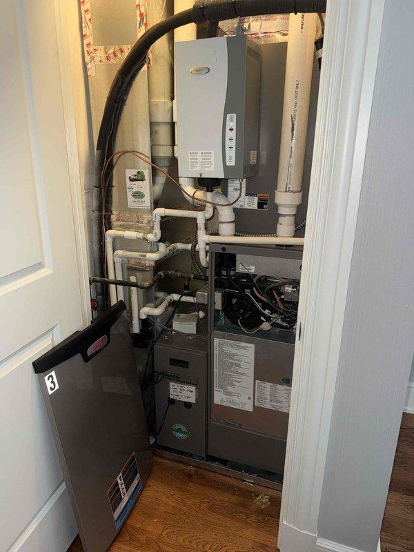 Responded to no heat call for 10+ year old furnace and AC system located in upstairs closet. Upon arrival, confirmed both units were completely non-operational with no power to system. Performed diagnostic inspection of furnace control board, wiring connections, and safety switches. Identified failed pressure switch preventing furnace ignition sequence from initiating. Inspected pressure switch tubing for blockages and verified proper connections. Documented internal wiring configuration and component layout showing multi-pin connector housing, control module, and safety devices. Pressure switch has been ordered and is available for pickup under PO: 1308894-001 for installation to restore system operation.