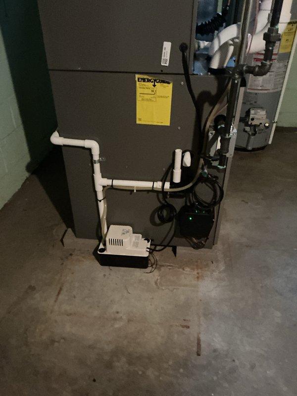 Completed AC system start-up and inspection on split HVAC system consisting of air handler unit in attic space and furnace unit in basement. Verified proper refrigerant line connections, condensate drainage system operation with functional pump, and electrical connections throughout. All equipment powered on successfully with no operational issues detected, system running within normal parameters.