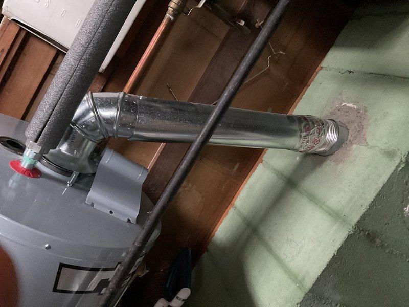 Responded to no hot water complaint at residential property. Upon inspection, located water heater in utility room and assessed unit condition. Documented existing water heater installation, including connected supply lines, exhaust venting, and pressure relief valve configuration. Customer reported persistent lack of hot water availability throughout the residence.