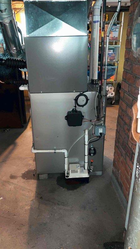 Completed installation of 2-ton air conditioning system with evaporator coil in rear basement location. Unit was properly mounted, connected to existing ductwork, and integrated with furnace system. All refrigerant lines, condensate drainage via PVC piping, and electrical conduit were installed per manufacturer specifications. System was tested for proper operation with thermostat controls. Mechanical and electrical permits were obtained prior to installation, with electrical reconnection coordinated through licensed electrician as required.