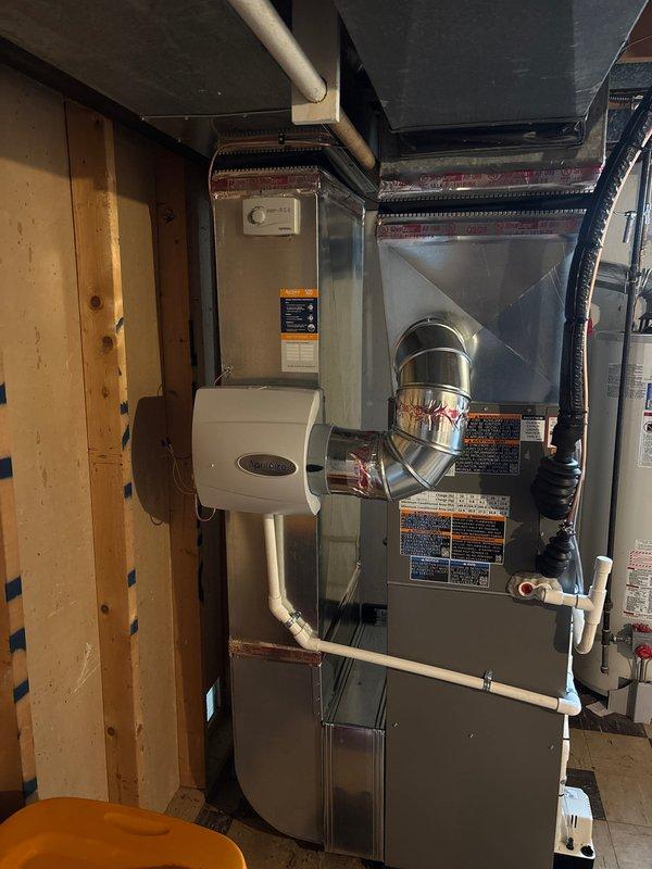 Completed full HVAC system installation including a 70,000 BTU furnace and 2-ton air conditioning unit with rear discharge configuration. Installed humidifier, condensate pump, and all necessary ductwork connections. Requested mechanical and electrical permits prior to installation. Performed complete system startup, refrigerant charging, and vacuum testing using manifold gauges to verify proper pressurization and system integrity. Reconnected all electrical and gas connections per manufacturer specifications. System tested and operational, meeting all code requirements. Documentation submitted for utility rebates through Consumers Energy and DTE Energy programs. AHRI certificate number recorded for rebate processing.